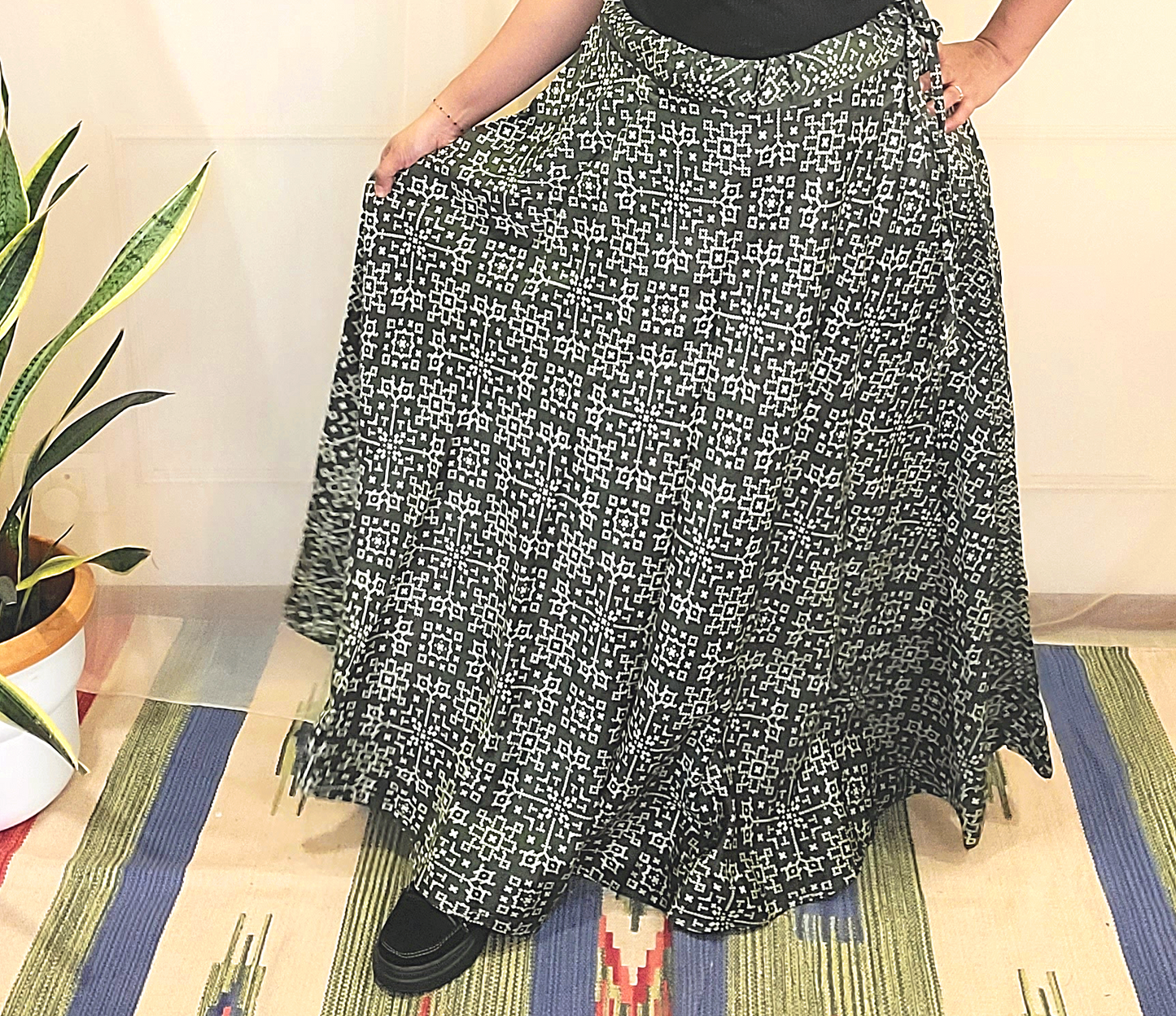 A women wear shiny silk olive green  side string skirt with prints 